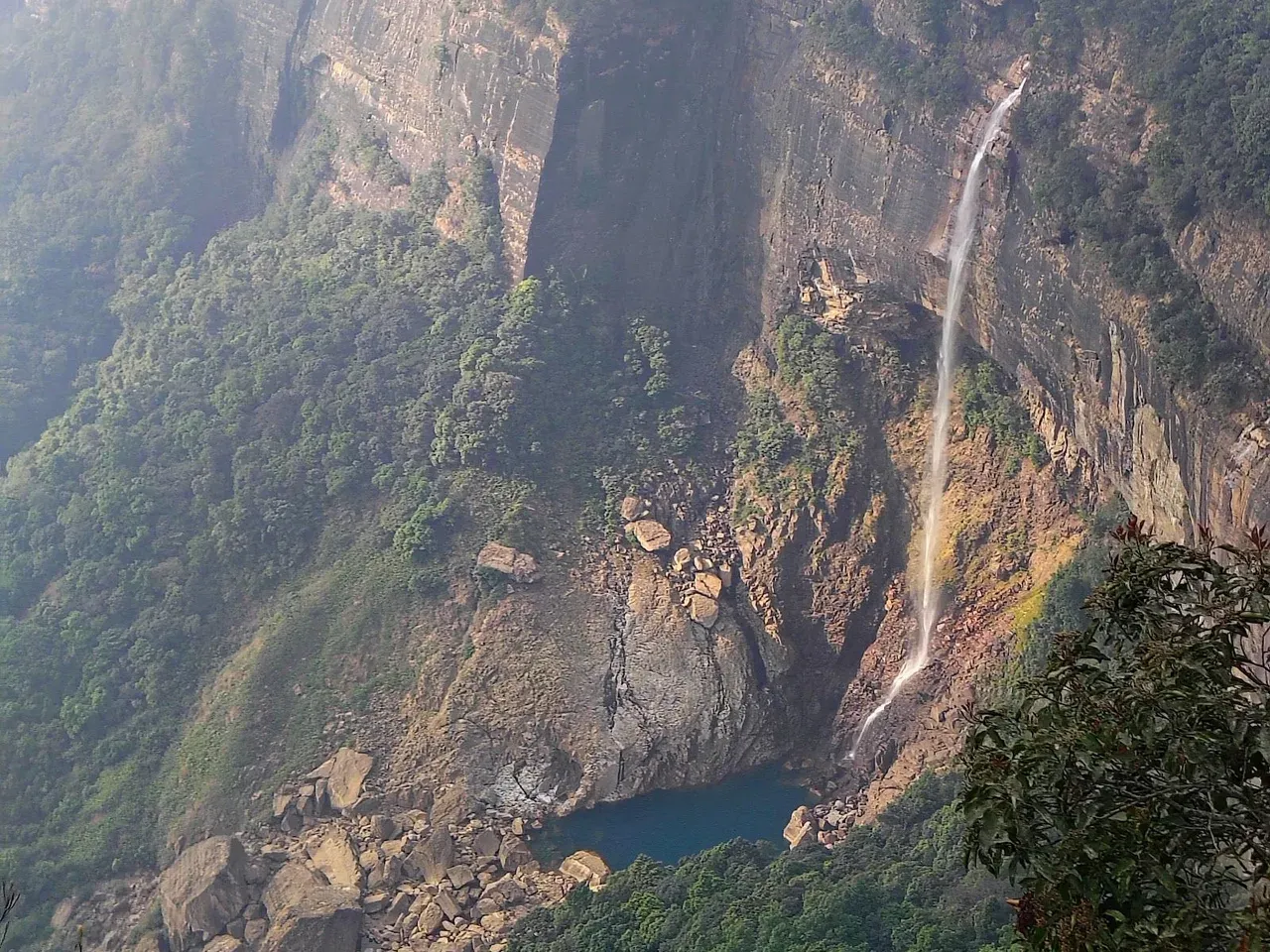 Waterfall down a green gorge