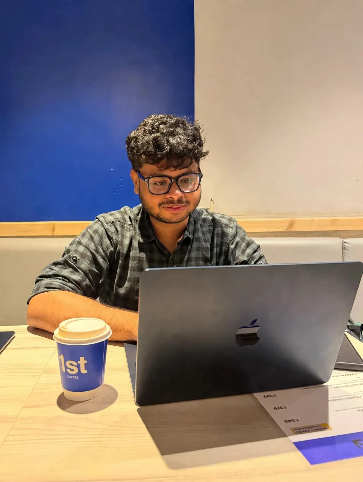 Arsal working on a laptop in a café